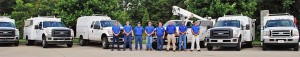 OEC Petroleum Systems Technicians in front of gas station equipment service trucks